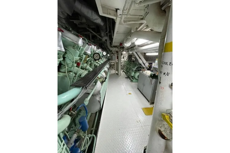  Yacht Photos Pics Engine room of 1974 SCHICHAU UNTERWESER AG Expedition Vessel, showcasing machinery and pipes.