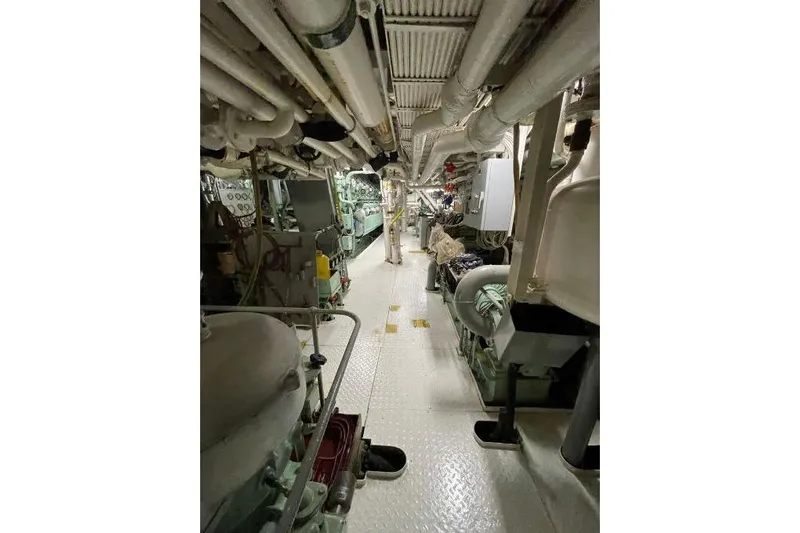  Yacht Photos Pics Engine room of 1974 SCHICHAU UNTERWESER AG Expedition Vessel, showcasing complex machinery and piping.