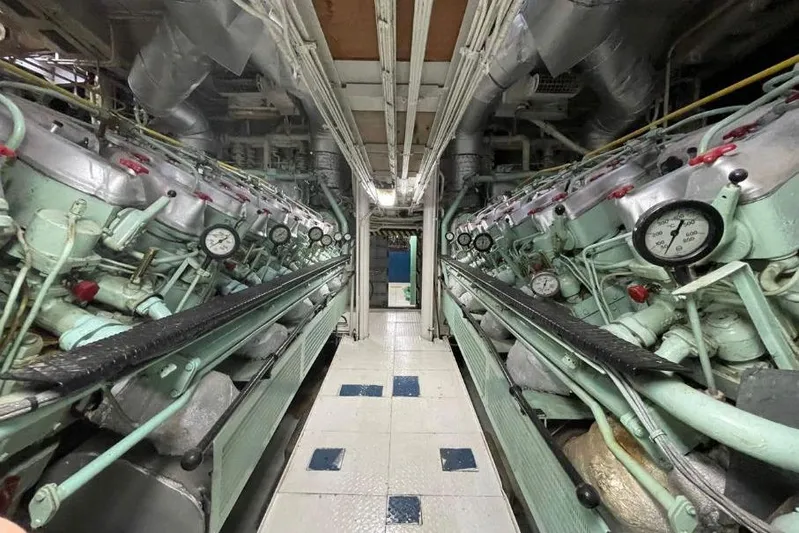  Yacht Photos Pics Engine room of 1974 SCHICHAU UNTERWESER AG Expedition Vessel, showcasing complex machinery and gauges.