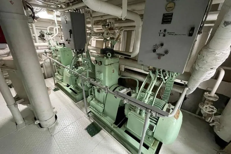  Yacht Photos Pics Engine room of 1974 SCHICHAU UNTERWESER AG Expedition Vessel, showcasing machinery and control panels.