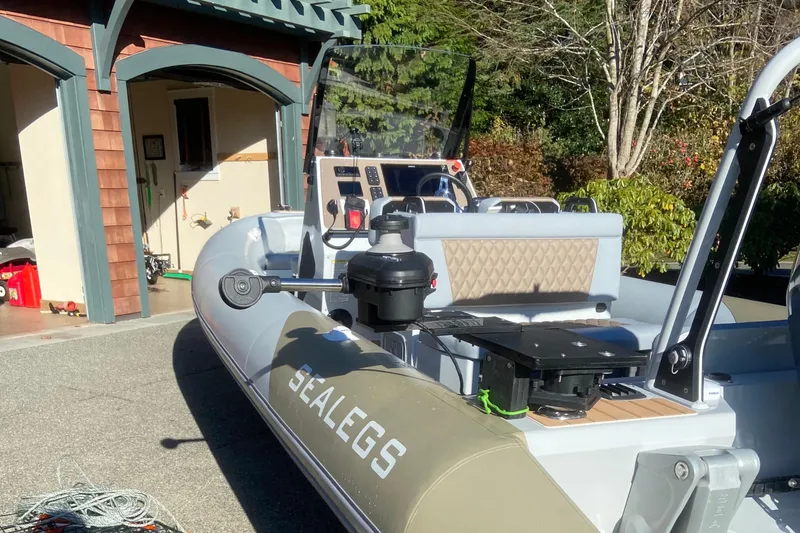  Yacht Photos Pics 2022 Sealegs 7.5M amphibious boat parked near a garage, showcasing its advanced features.