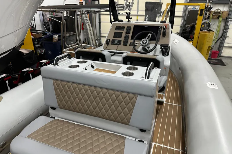  Yacht Photos Pics 2022 Sealegs 7.5M boat interior with steering console and cushioned seating.