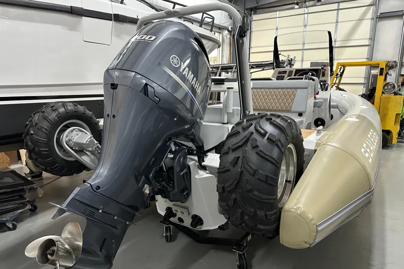  Yacht Photos Pics 2022 Sealegs 7.5M amphibious boat with Yamaha engine in a garage setting.