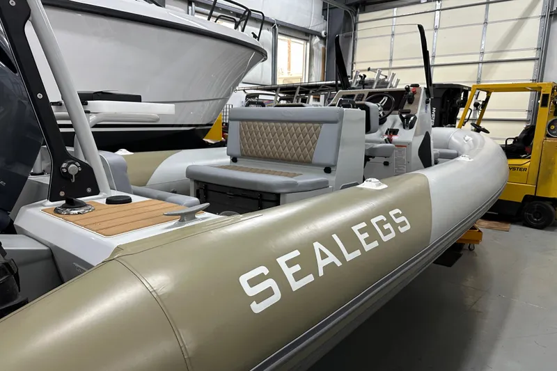  Yacht Photos Pics 2022 Sealegs 7.5M amphibious boat in a showroom, featuring sleek design and seating.