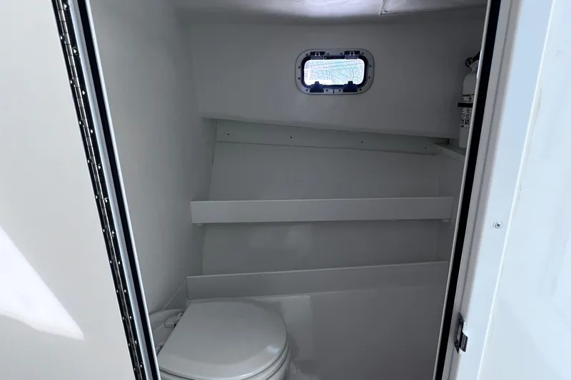  Yacht Photos Pics 2022 Steiger Craft 31 Chesapeake boat interior bathroom with compact toilet and small window.