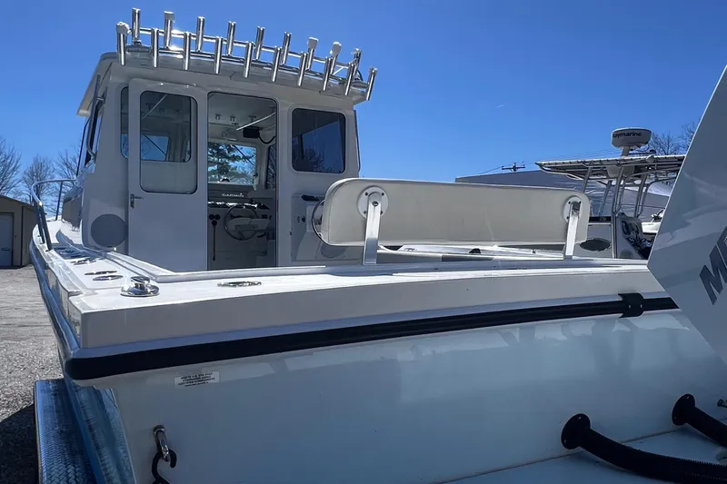  Yacht Photos Pics 2022 Steiger Craft 31 Chesapeake boat, rear view, showcasing spacious deck and fishing rod holders.