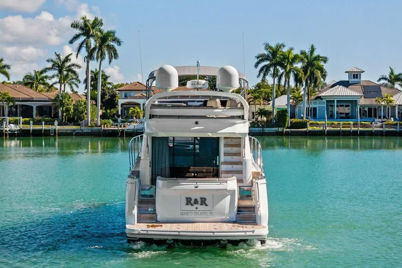 R&r Yacht Photos Pics 2023 Princess F50 yacht cruising in a tropical waterfront setting with palm trees.