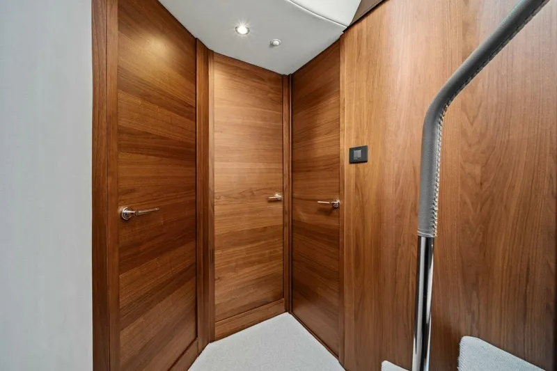 R&r Yacht Photos Pics Luxurious wooden interior of 2023 Princess F50 yacht, featuring sleek doors and modern design.