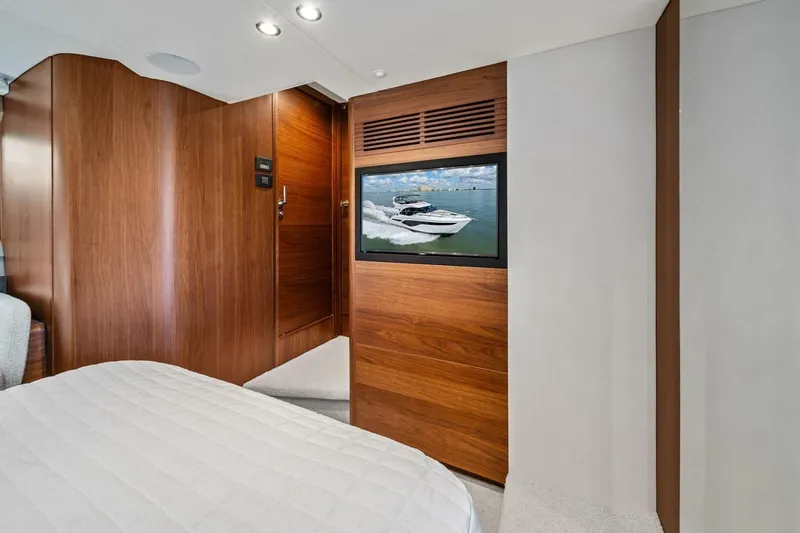 R&r Yacht Photos Pics Luxurious 2023 Princess F50 yacht interior with wood paneling and a mounted TV.