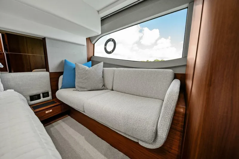 R&r Yacht Photos Pics Luxurious interior of 2023 Princess F50 yacht with elegant sofa and scenic window view.