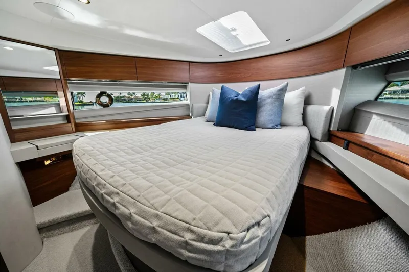 R&r Yacht Photos Pics Luxurious interior of 2023 Princess F50 yacht with elegant bedding and wood accents.