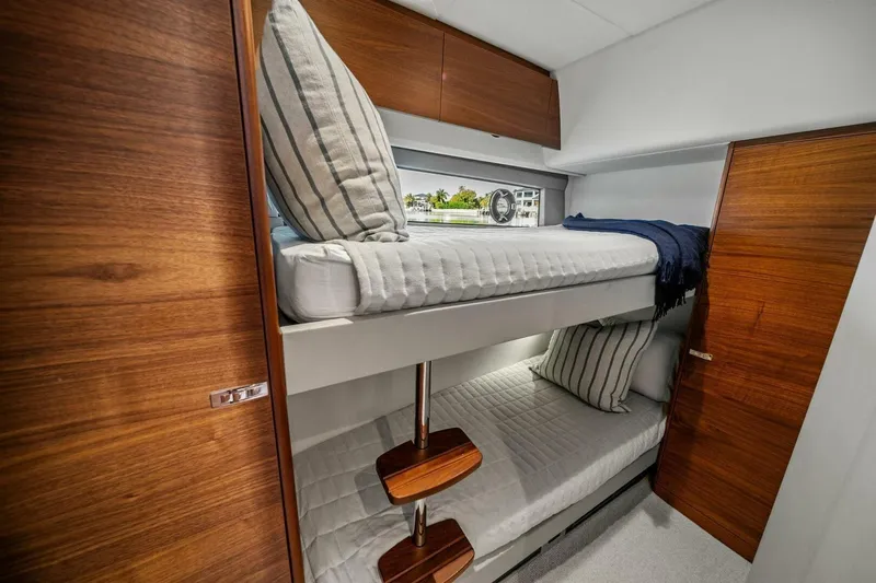 R&r Yacht Photos Pics Luxurious 2023 Princess F50 yacht cabin with wooden finishes and bunk beds.