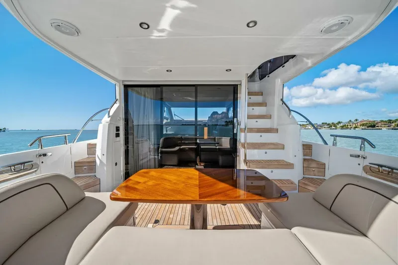 R&r Yacht Photos Pics Luxurious 2023 Princess F50 yacht interior with elegant seating and wooden table.