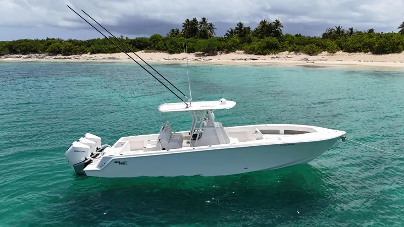  Yacht Photos Pics 2024 SeaVee 340Z boat in clear turquoise water near a tropical beach.