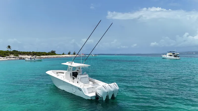  Yacht Photos Pics 2024 SeaVee 340Z boat on turquoise water near a tropical shoreline.