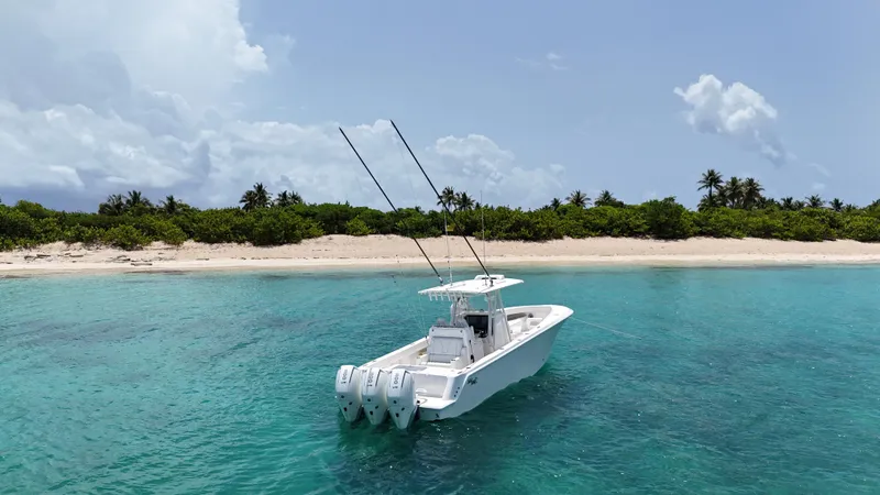  Yacht Photos Pics 2024 SeaVee 340Z boat in clear turquoise water near a sandy beach.