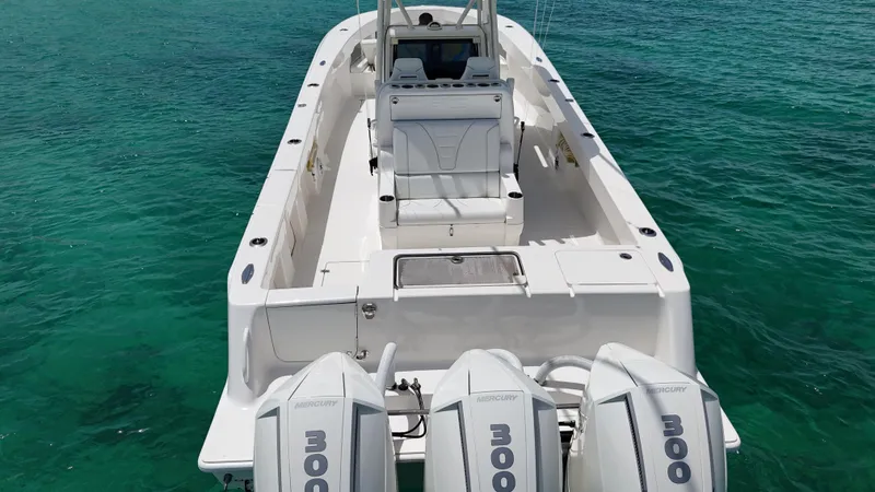  Yacht Photos Pics 2024 SeaVee 340Z boat with triple outboard engines on clear turquoise water.