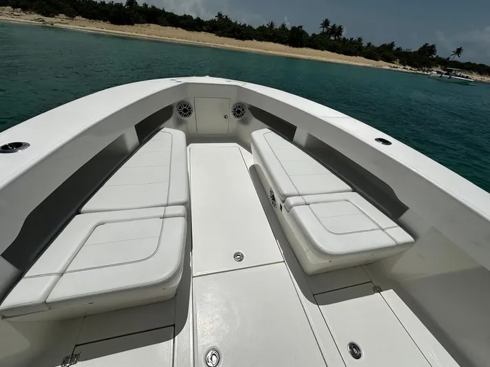  Yacht Photos Pics 2024 SeaVee 340Z boat interior with white seating, near a tropical beach.