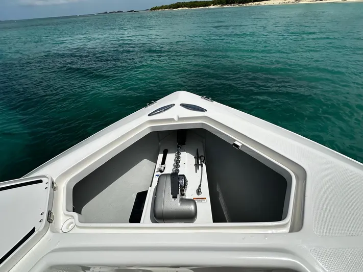  Yacht Photos Pics 2024 SeaVee 340Z boat bow with open storage, anchored in clear turquoise water.