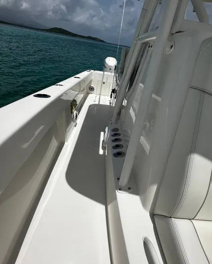  Yacht Photos Pics 2024 SeaVee 340Z boat deck with rod holders, on calm ocean waters.