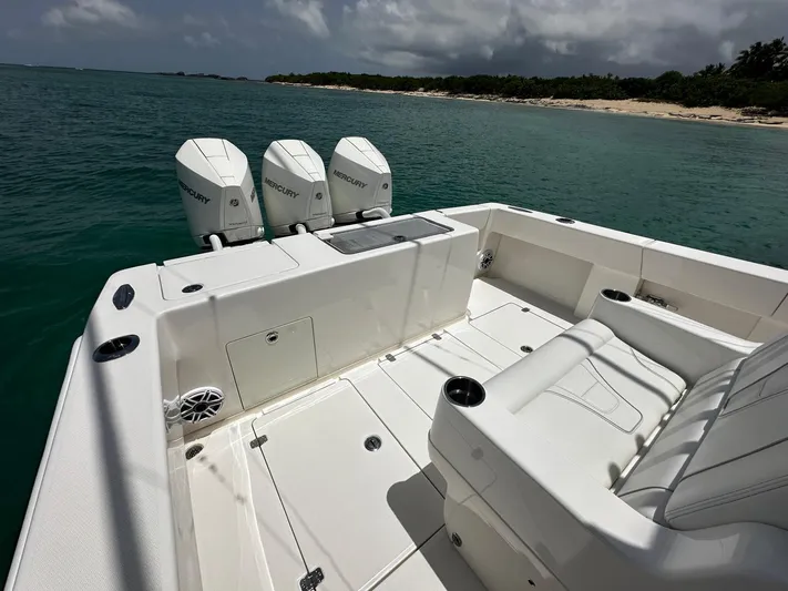  Yacht Photos Pics 2024 SeaVee 340Z boat with triple Mercury engines, white deck, near tropical shoreline.