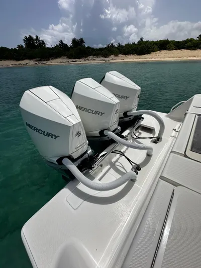  Yacht Photos Pics 2024 SeaVee 340Z boat with triple Mercury outboard engines near a sandy beach.