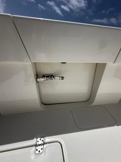  Yacht Photos Pics 2024 SeaVee 340Z boat compartment with latch under a clear blue sky.