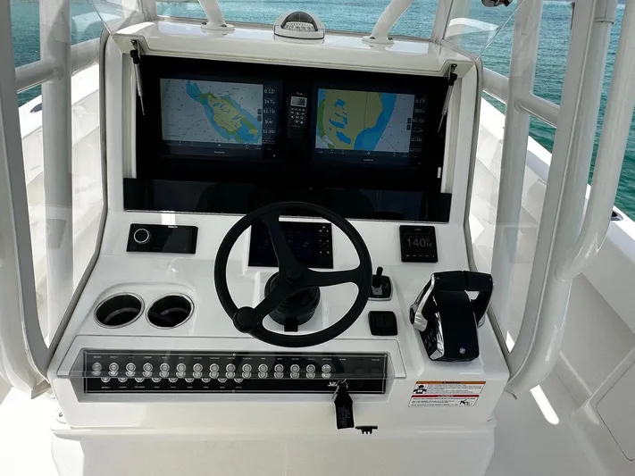  Yacht Photos Pics 2024 SeaVee 340Z boat dashboard with dual navigation screens and steering wheel.