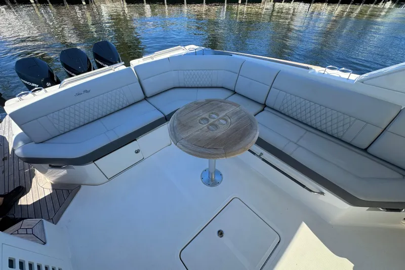 C3 Yacht Photos Pics Luxurious seating area on 2022 Sea Ray SLX 400 Outboard boat with wooden table.