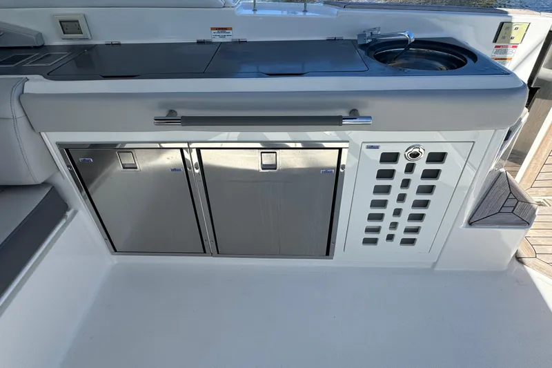 C3 Yacht Photos Pics 2022 Sea Ray SLX 400 Outboard boat kitchen with stainless steel appliances and sink.