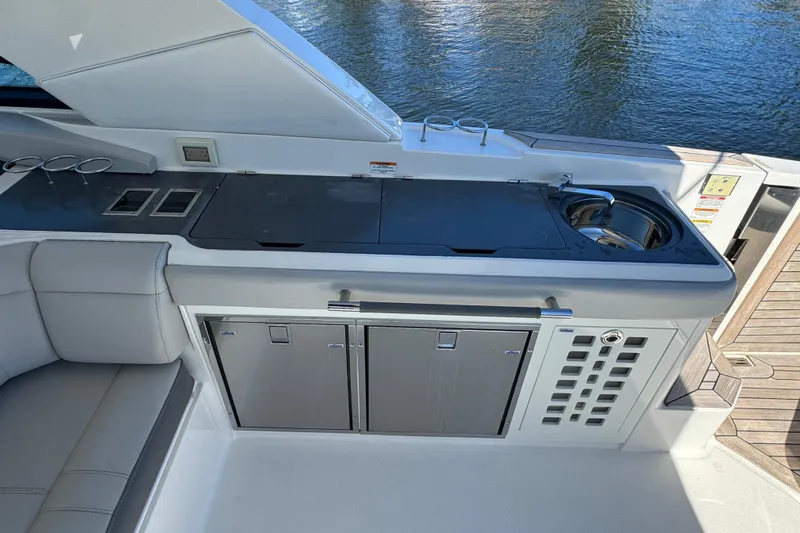 C3 Yacht Photos Pics 2022 Sea Ray SLX 400 Outboard boat kitchen with sink and storage cabinets.