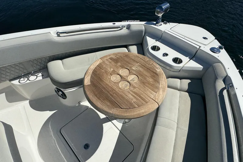 C3 Yacht Photos Pics 2022 Sea Ray SLX 400 Outboard boat interior with wooden table and cushioned seating.