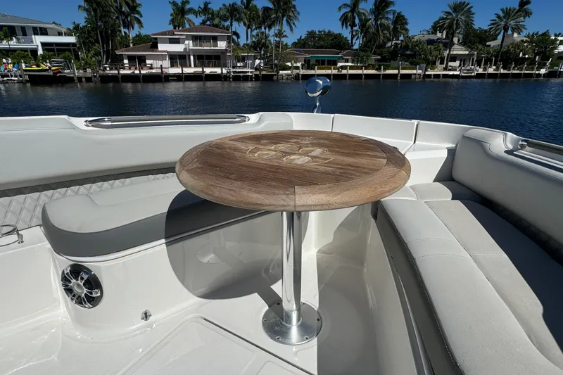 C3 Yacht Photos Pics Luxurious seating area on 2022 Sea Ray SLX 400 Outboard boat with wooden table.