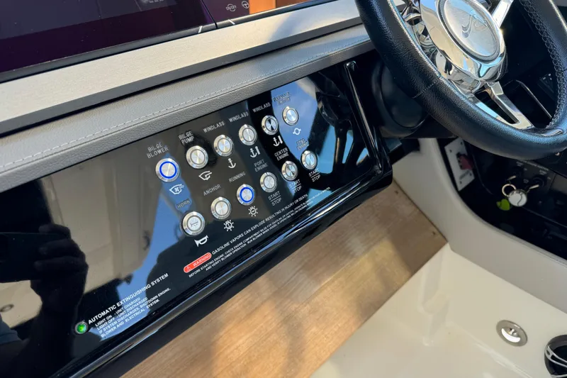 C3 Yacht Photos Pics Control panel of 2022 Sea Ray SLX 400 Outboard with steering wheel and various buttons.