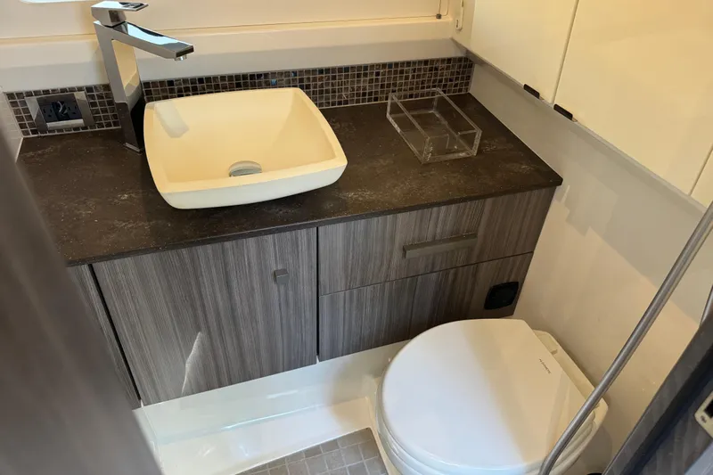 C3 Yacht Photos Pics Modern bathroom in 2022 Sea Ray SLX 400 Outboard with sleek sink and toilet.