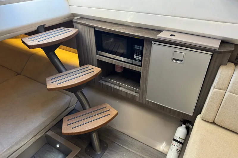 C3 Yacht Photos Pics Interior of 2022 Sea Ray SLX 400 Outboard with microwave, fridge, and wooden steps.