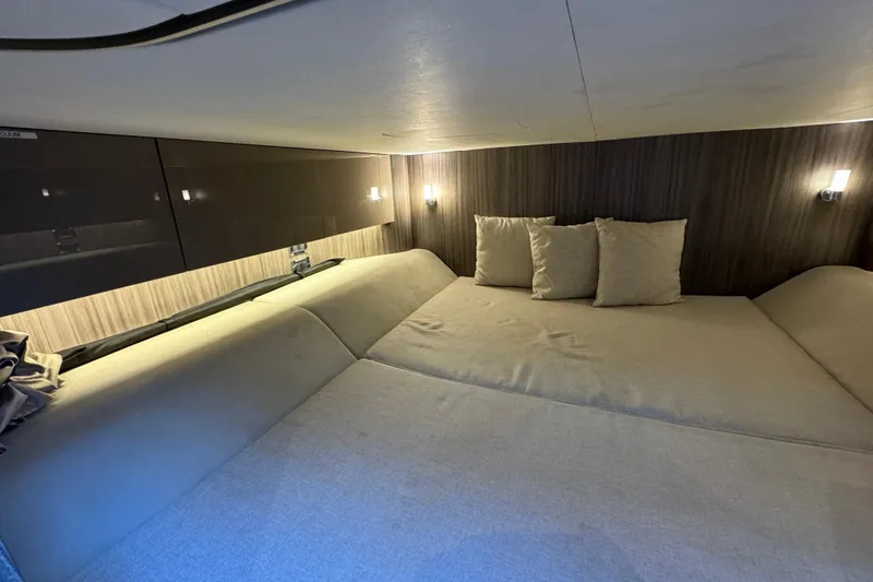 C3 Yacht Photos Pics Interior cabin of 2022 Sea Ray SLX 400 Outboard, featuring cozy bedding and ambient lighting.