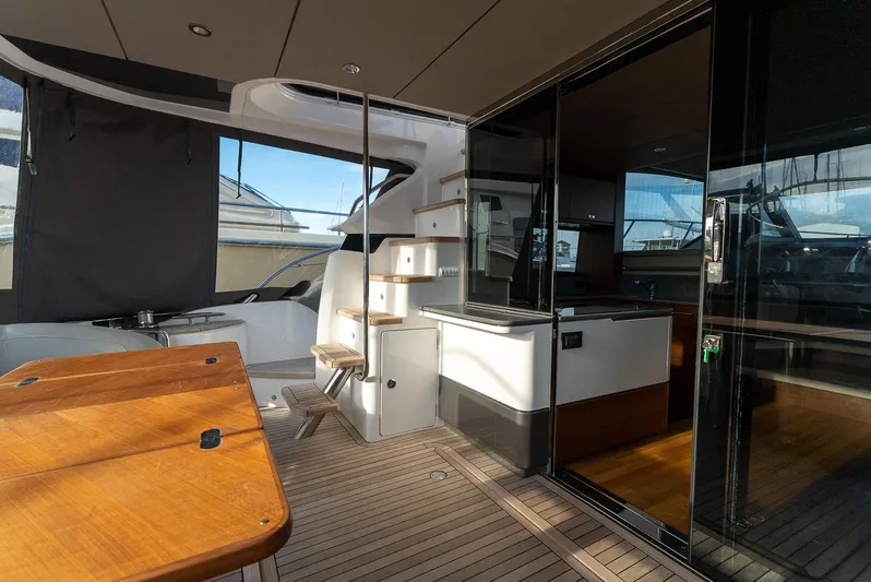 Yacht Photos Pics Luxurious 2024 Princess F55 yacht interior with wooden deck and modern amenities.