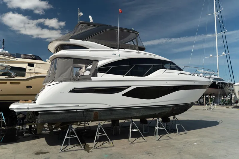  Yacht Photos Pics 2024 Princess F55 yacht on stands, sleek design, under clear blue sky.