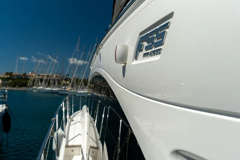  Yacht Photos Pics 2024 Princess F55 yacht docked in a marina, showcasing sleek design and branding.
