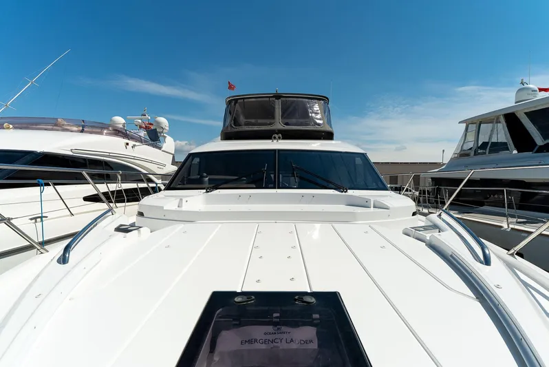  Yacht Photos Pics 2024 Princess F55 yacht docked under clear blue sky.