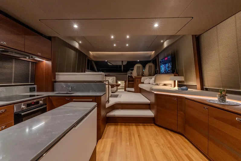  Yacht Photos Pics Luxurious interior of 2024 Princess F55 yacht with modern kitchen and seating area.