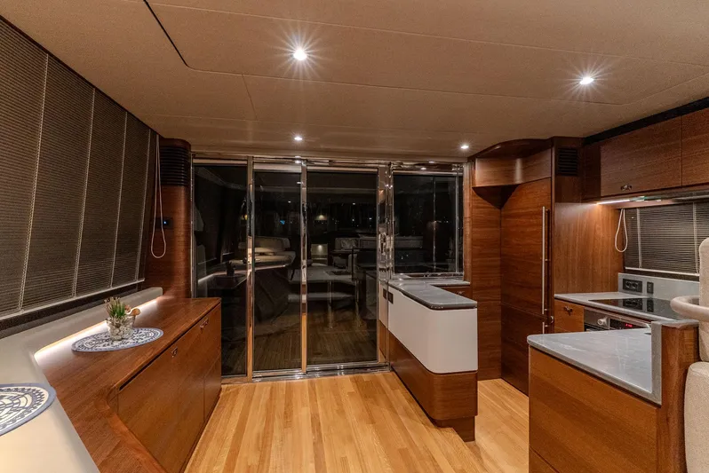 Yacht Photos Pics Luxurious interior of 2024 Princess F55 yacht with modern kitchen and elegant wood finishes.