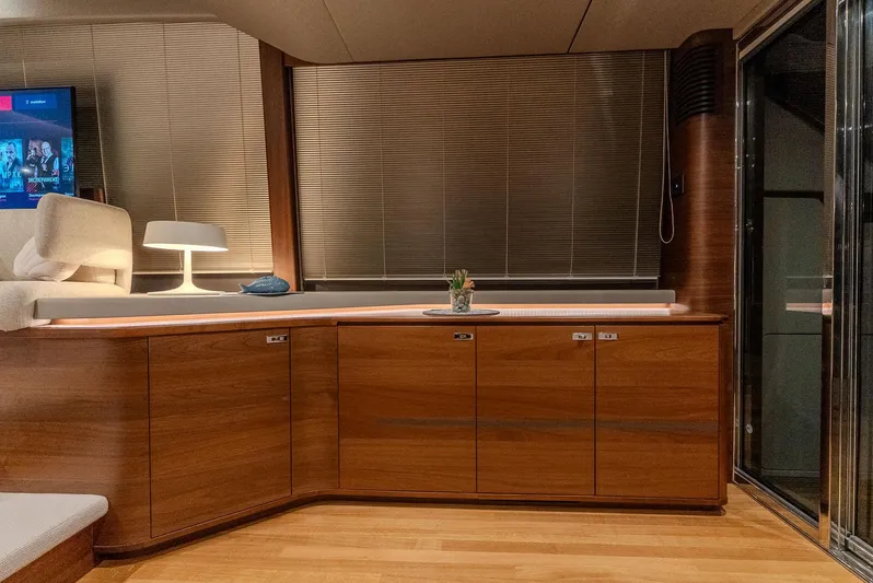  Yacht Photos Pics Luxurious interior of 2024 Princess F55 yacht with wooden cabinetry and modern decor.
