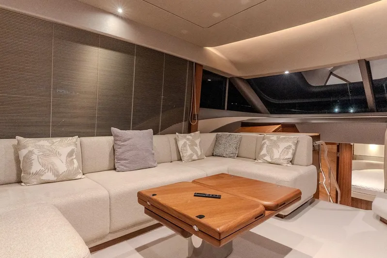 Yacht Photos Pics Luxurious interior of 2024 Princess F55 yacht with elegant seating and wooden table.