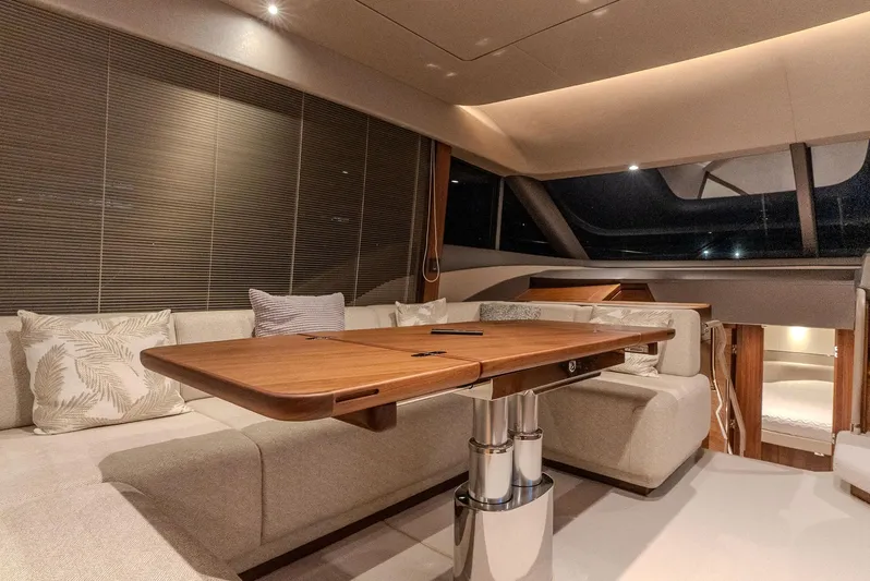  Yacht Photos Pics Luxurious interior of 2024 Princess F55 yacht with elegant seating and wooden table.