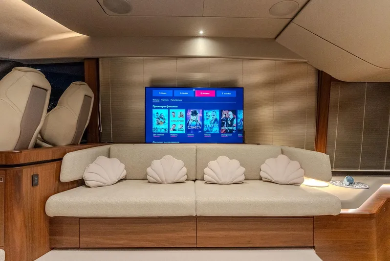  Yacht Photos Pics Luxurious 2024 Princess F55 yacht interior with plush seating and entertainment system.