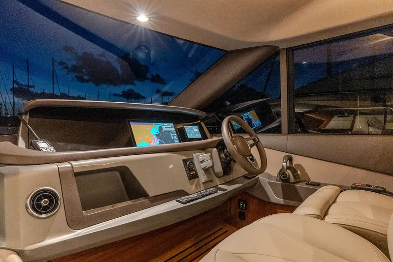  Yacht Photos Pics Luxurious 2024 Princess F55 yacht cockpit with advanced navigation systems at dusk.