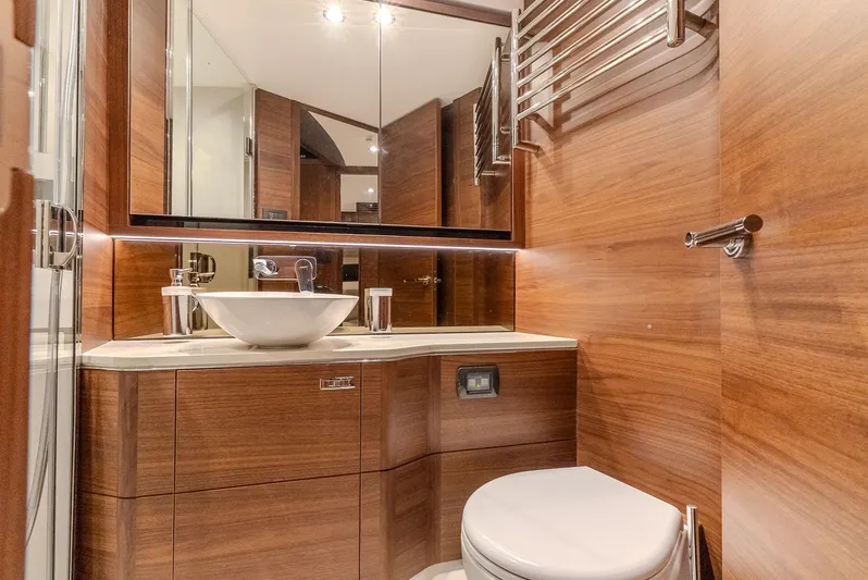  Yacht Photos Pics Luxurious bathroom in 2024 Princess F55 yacht with wood paneling and modern fixtures.