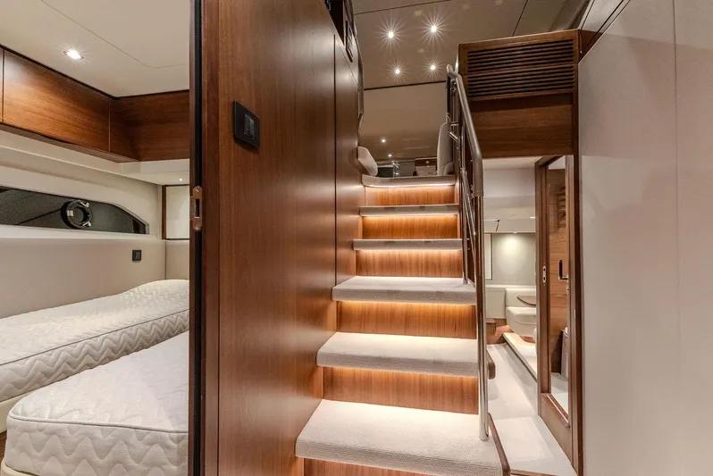  Yacht Photos Pics Luxurious interior of 2024 Princess F55 yacht with wooden stairs and twin beds.